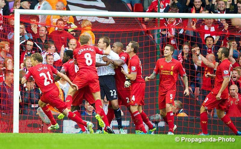 Mignolet mobbed after the penalty save (Pic: David Rawclifee / Propaganda)