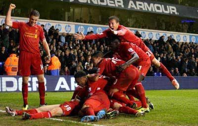 SUPER FLAN: Jon Flanagan is mobbed after his superb first goal for Liverpool