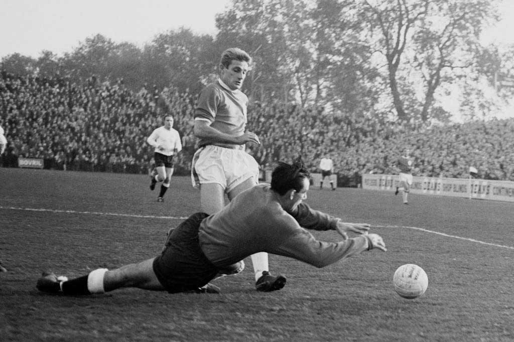 Fulham goalkeeper Tony Macedo dives at the feet of Liverpool's Roger Hunt