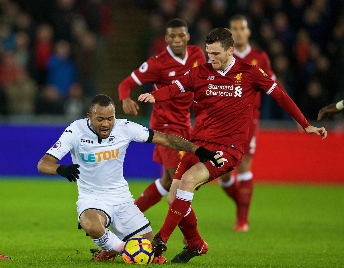 SWANSEA, WALES - Monday, January 22, 2018: Liverpool's Andy Robertson and Swansea City's Jordan Ayew during the FA Premier League match between Swansea City FC and Liverpool FC at the Liberty Stadium. (Pic by David Rawcliffe/Propaganda)