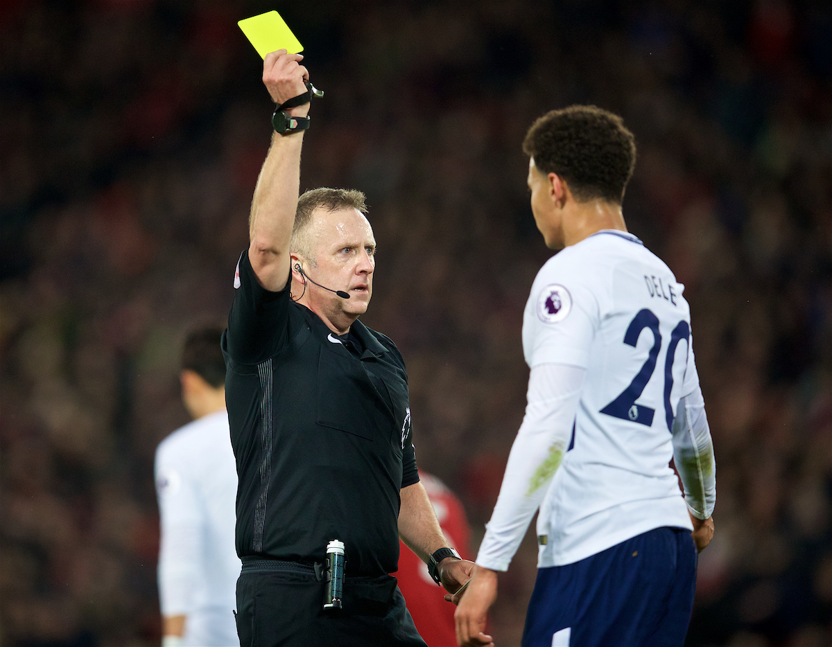 LIVERPOOL, ENGLAND - Sunday, February 4, 2018: Tottenham Hotspur's Dele Alli is shown a yellow card by referee Jonathan Moss for diving (simulation) during the FA Premier League match between Liverpool FC and Tottenham Hotspur FC at Anfield. (Pic by David Rawcliffe/Propaganda)