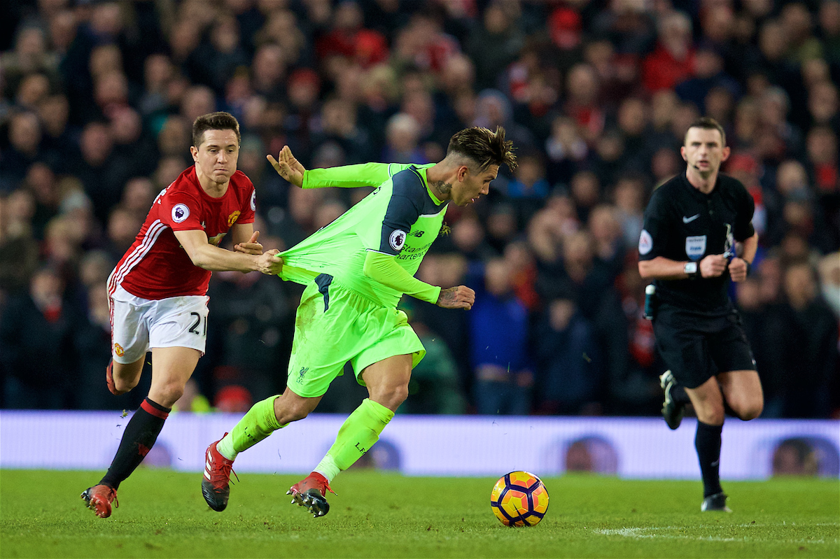 MANCHESTER, ENGLAND - Sunday, January 15, 2017: Liverpool's Roberto Firmino is held back by Manchester United's Ander Herrera as he pulls his shirt during the FA Premier League match at Old Trafford. (Pic by David Rawcliffe/Propaganda)g
