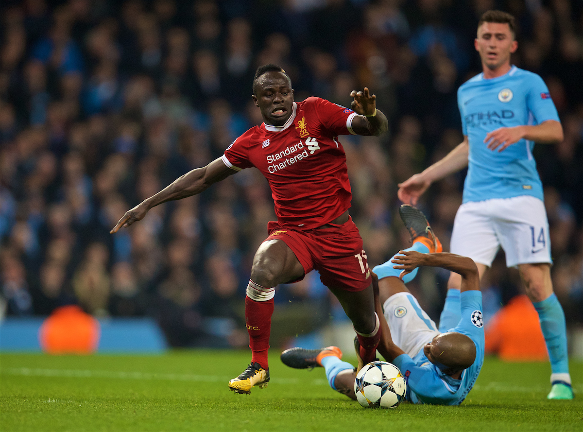 MANCHESTER, ENGLAND - Tuesday, April 10, 2018: Liverpool's Sadio Mane (left) is brought down by Manchester City's Fernando Luiz Roza 'Fernandinho' but the referee allows play-on for the Reds to score a vital away equalising goal and level the score at 1-1 during the UEFA Champions League Quarter-Final 2nd Leg match between Manchester City FC and Liverpool FC at the City of Manchester Stadium. (Pic by David Rawcliffe/Propaganda)