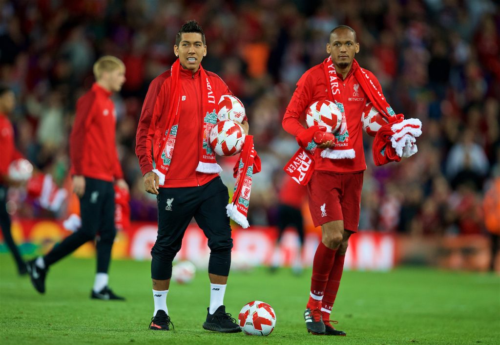 LIVERPOOL, ENGLAND - Tuesday, August 7, 2018: Liverpool's Roberto Firmino and Fabio Henrique Tavares 'Fabinho' hand out balls and scarves top supporters after the preseason friendly match between Liverpool FC and Torino FC at Anfield. (Pic by David Rawcliffe/Propaganda)