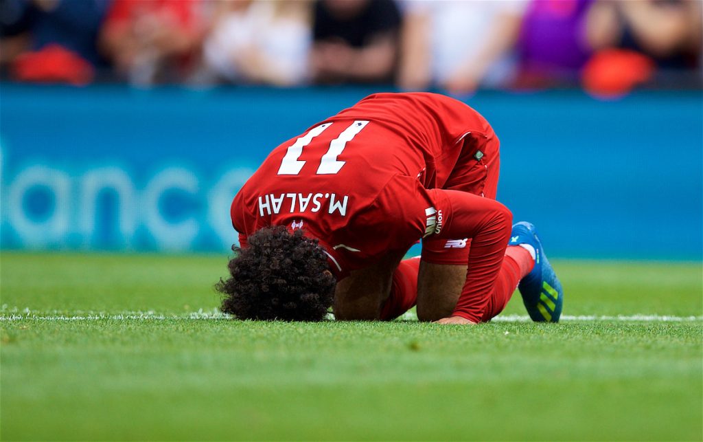 LIVERPOOL, ENGLAND - Sunday, August 12, 2018: Liverpool's Mohamed Salah,kneels to pray as he celebrates scoring the first goal during the FA Premier League match between Liverpool FC and West Ham United FC at Anfield. (Pic by David Rawcliffe/Propaganda)