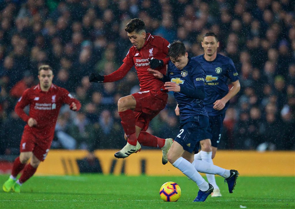 LIVERPOOL, ENGLAND - Sunday, December 16, 2018: Liverpool's Roberto Firmino and Manchester United's Victor Lindelöf during the FA Premier League match between Liverpool FC and Manchester United FC at Anfield. (Pic by David Rawcliffe/Propaganda)