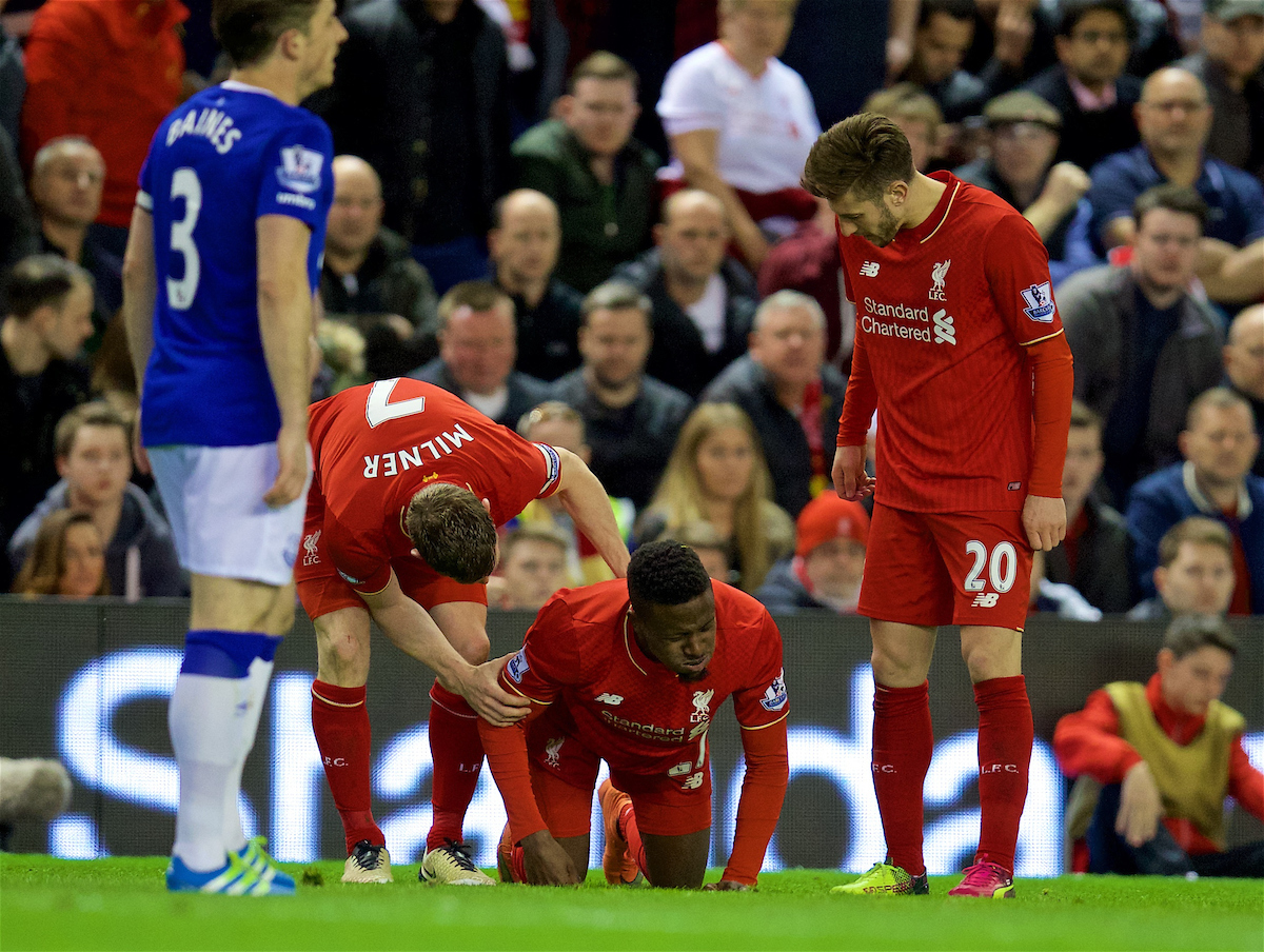 LIVERPOOL, ENGLAND - Wednesday, April 20, 2016: Liverpool's Divock Origi lies injured during the Premier League match against Everton at Anfield, the 226th Merseyside Derby. (Pic by David Rawcliffe/Propaganda)