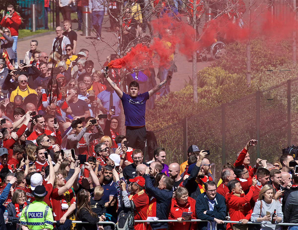 LIVERPOOL, ENGLAND - Sunday, May 12, 2019: A Liverpool supporter waits for the team bus to arrive with a red smoke bomb before the final FA Premier League match of the season between Liverpool FC and Wolverhampton Wanderers FC at Anfield. (Pic by David Rawcliffe/Propaganda)