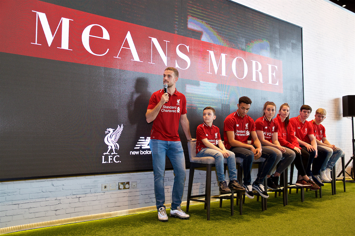 LIVERPOOL, ENGLAND - Tuesday, April 17, 2018: Liverpool captain Jordan Henderson with competition winner Spencer Davis, Trent Alexander-Arnold, Ladies players Amy Turner and  Ellie Fletcher, and Liverpool Under-18's players Liam Coyle and Edvard Tagseth during a press event to reveal the team's new kits for the 2018-19 season at the official club store at Anfield. (Pic by Jason Roberts/Propaganda)