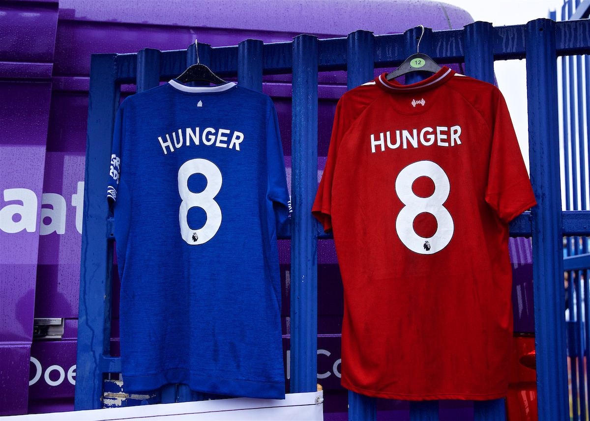 LIVERPOOL, ENGLAND - Sunday, March 3, 2019: An Everton and Liverpool shirt hanging side--by-side with "8 Hunger" on them at a Food Bank during the FA Premier League match between Everton FC and Liverpool FC, the 233rd Merseyside Derby, at Goodison Park.  Supporters of both clubs give to food banks, set up to help feed people left with no money due to the Conservative government's evil austerity measures. (Pic by Laura Malkin/Propaganda)