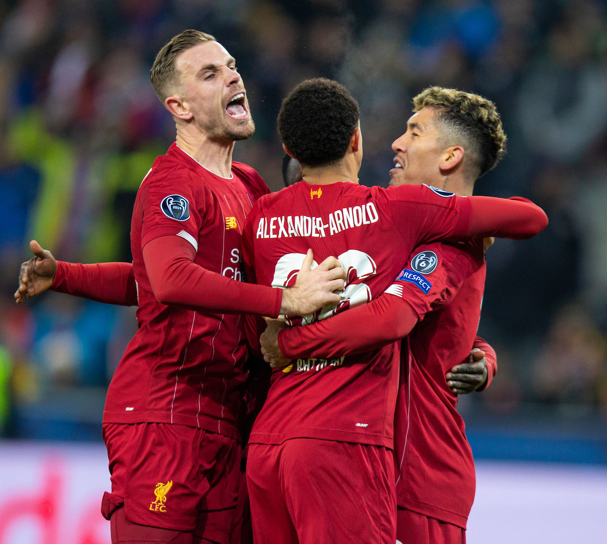 SALZBURG, AUSTRIA - Tuesday, December 10, 2019: Liverpool players captain Jordan Henderson, Trent Alexander-Arnold and Roberto Firmino celebrate the opening goal scored by Sadio Mané (hidden) during the final UEFA Champions League Group E match between FC Salzburg and Liverpool FC at the Red Bull Arena. (Pic by David Rawcliffe/Propaganda)