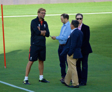 Liverpool's manager Jürgen Klopp chats with co-owner and FSG Chairman Tom Werner, owner John W. Henry and Director Michael Gordon during a training session