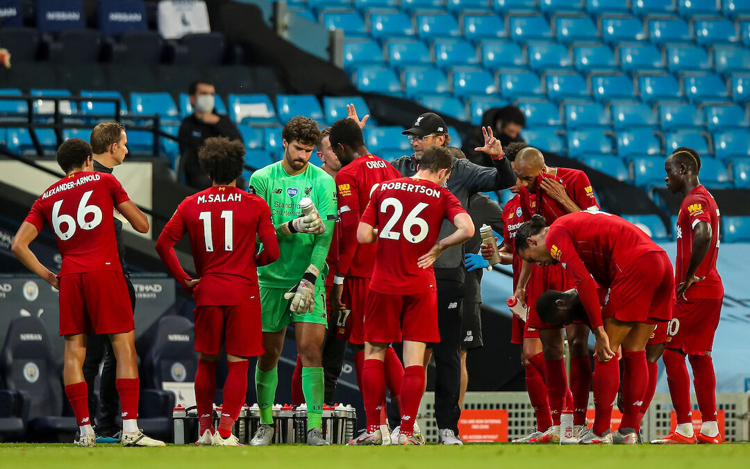 Liverpool’s manager Jürgen Klopp speaks to his players during a water break during the FA Premier League match between Manchester City FC and Liverpool FC at the Eithad Stadium
