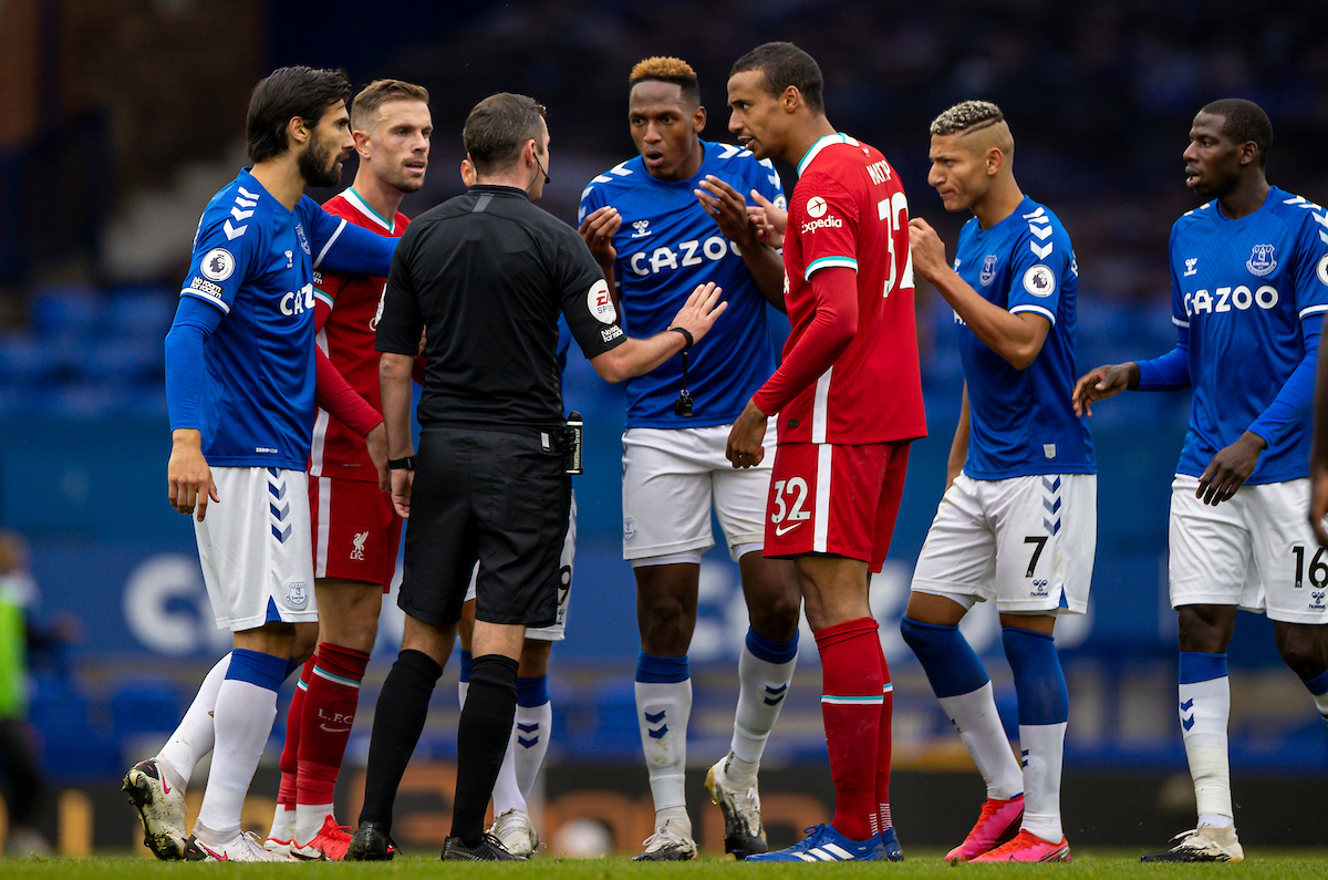 Everton's André Gomes, Yerry Mina, Richarlison de Andrade and Liverpool's captain Jordan Henderson and Joel Matip argue with referee Michael Oliver during the FA Premier League match between Everton FC and Liverpool FC, the 237th Merseyside Derby, at Goodison Park