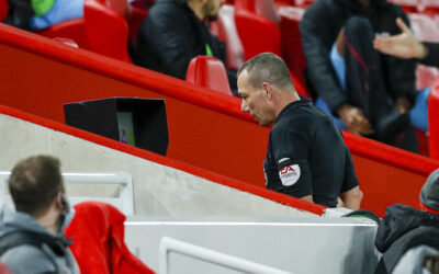 Referee Kevin Friend reviews an incident on the VAR
