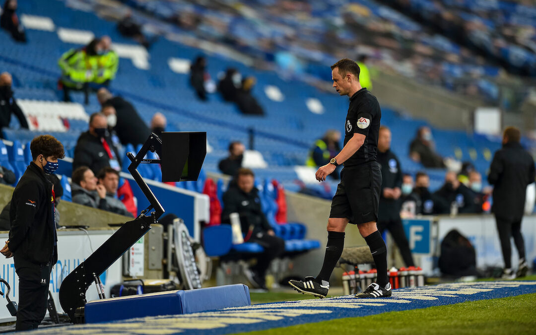 Referee Stuart Atwell looks at the VAR monitor during the FA Premier League match between Brighton & Hove Albion FC and Liverpool FC at the AMEX Stadium