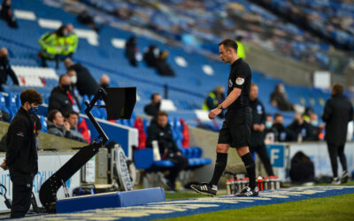 Referee Stuart Atwell looks at the VAR monitor during the FA Premier League match between Brighton & Hove Albion FC and Liverpool FC at the AMEX Stadium