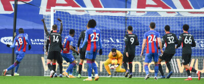 Liverpool's goalkeeper Alisson Becker makes a save during the FA Premier League match between Crystal Palace FC and Liverpool FC at Selhurst Park