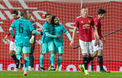 Liverpool's Mohamed Salah (R) celebrates with team-mate Roberto Firmino after scoring the second goal, to level the score 2-2, during the FA Cup 4th Round match between Manchester United FC and Liverpool FC at Old Trafford