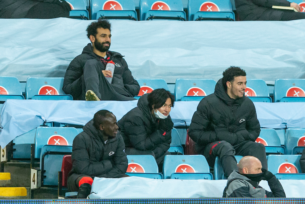 Liverpool's substituted players Sadio Mané, Mohamed Salah. Takumi Minamino anmd Curtis Jones sit in the stands during the FA Cup 3rd Round match between Aston Villa FC and Liverpool FC at Villa Park