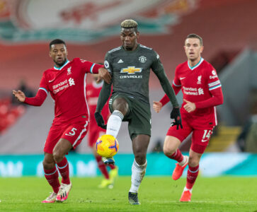 Manchester United's Paul Pogba (C) and Liverpool's Georginio Wijnaldum (L) during the FA Premier League match between Liverpool FC and Manchester United FC at Anfield