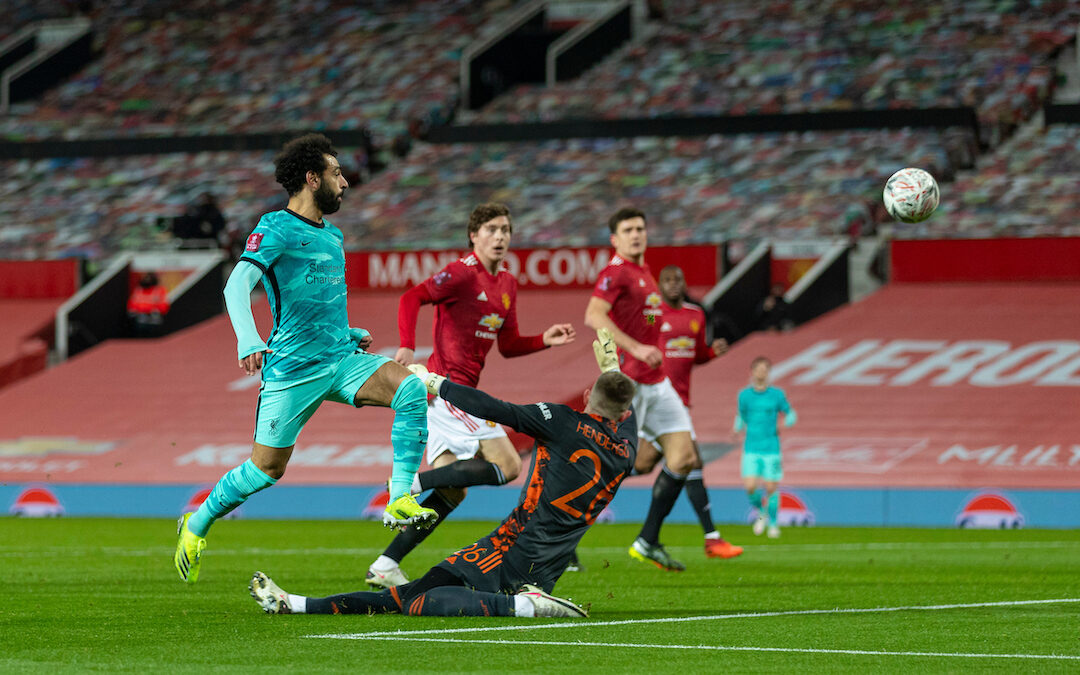 Liverpool's Mohamed Salah scores the first goal chipping the ball over Manchester United's goalkeeper Dean Henderson during the FA Cup 4th Round match between Manchester United FC and Liverpool FC at Old Trafford