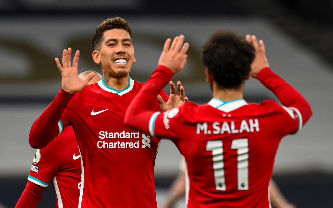 Liverpool's Roberto Firmino (L) celebrates with team-mate Mohamed Salah (R) after scoring the first goal with the last kick of the first half during the FA Premier League match between Tottenham Hotspur FC and Liverpool FC at the Tottenham Hotspur Stadium
