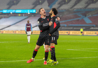 Liverpool's Mohamed Salah celebrates with team-mate captain Jordan Henderson (L) after scoring the second goal during the FA Premier League match between West Ham United FC and Liverpool FC at the London Stadium