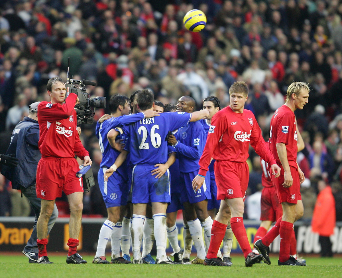 Chelsea's players celebrate their 1-0 victory as Liverpool players walk off dejected after the Premiership match at Anfield