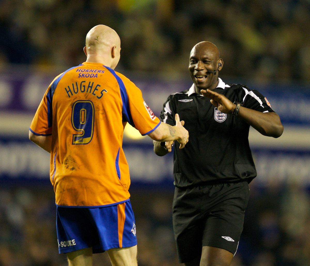 Oldham Athletic's Lee Hughes and referee Uriah Rennie his side's 1-0 victory over Everton during the FA Cup 3rd Round match at Goodison Park
