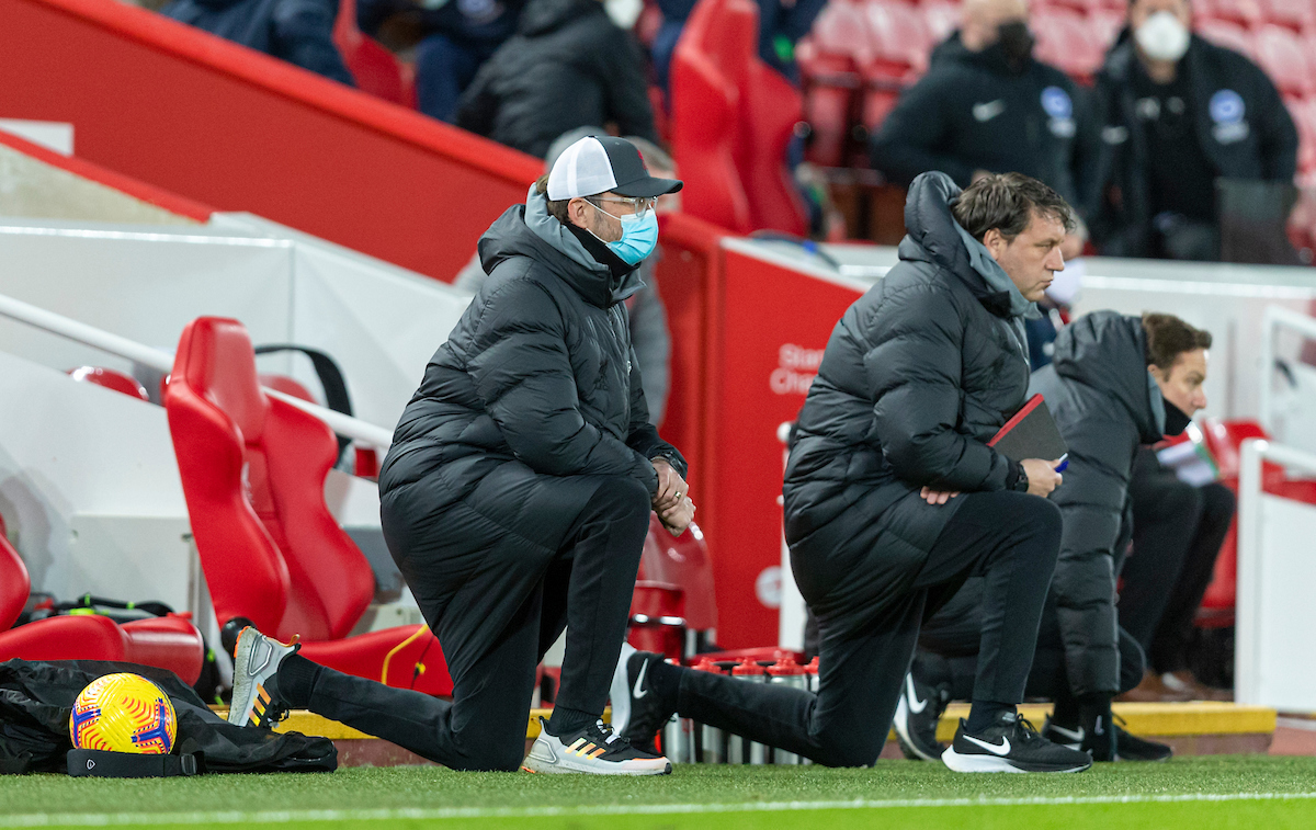 Liverpool's manager Jürgen Klopp kneels down (takes a knee) in support of the Black Lives Matter movement before the FA Premier League match between Liverpool FC and Brighton & Hove Albion FC at Anfield