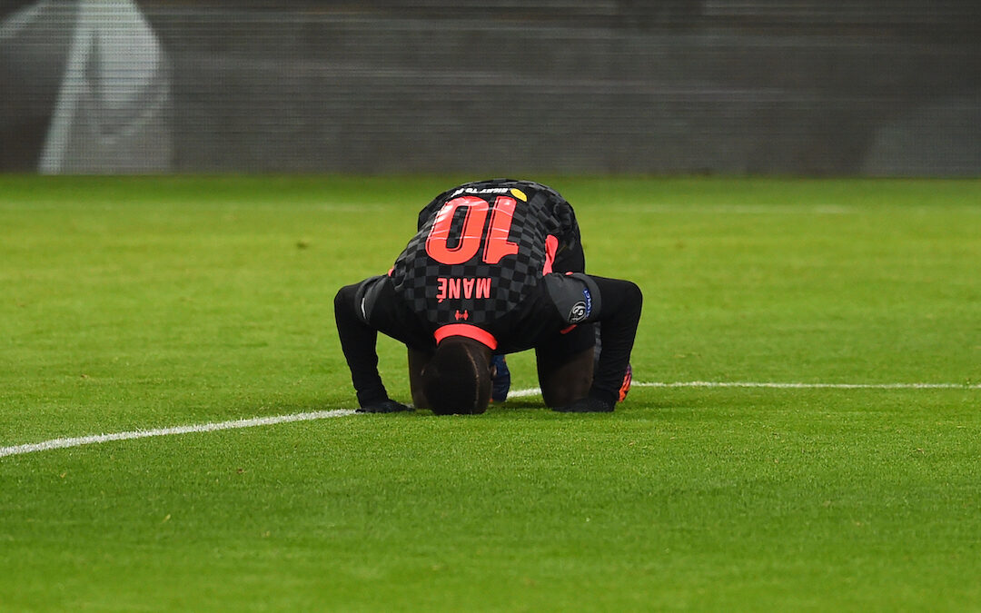 Liverpool's Sadio Mané kneels to pray as he celebrates after scoring the second goal during the UEFA Champions League Round of 16 1st Leg game between RB Leipzig and Liverpool FC at the Puskás Aréna