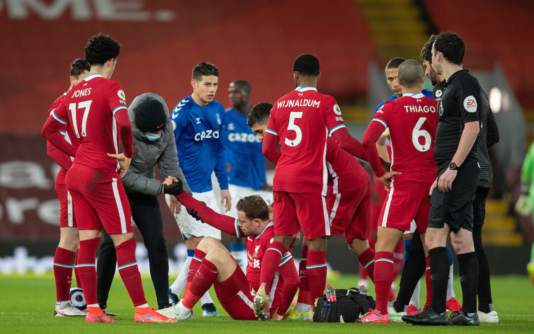 Liverpool's captain Jordan Henderson goes down injured during the FA Premier League match between Liverpool FC and Everton FC, the 238th Merseyside Derby, at Anfield