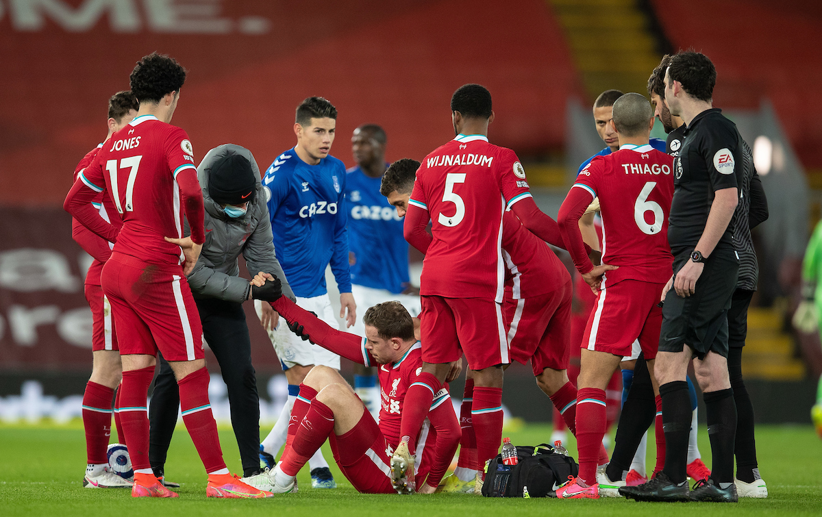 Liverpool's captain Jordan Henderson goes down injured during the FA Premier League match between Liverpool FC and Everton FC, the 238th Merseyside Derby, at Anfield