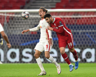 Liverpool's Ozan Kabak and RB Leipzig's Yussuf Poulsen during the UEFA Champions League Round of 16 second Leg game between Liverpool FC and RB Leipzig at the Puskás Aréna