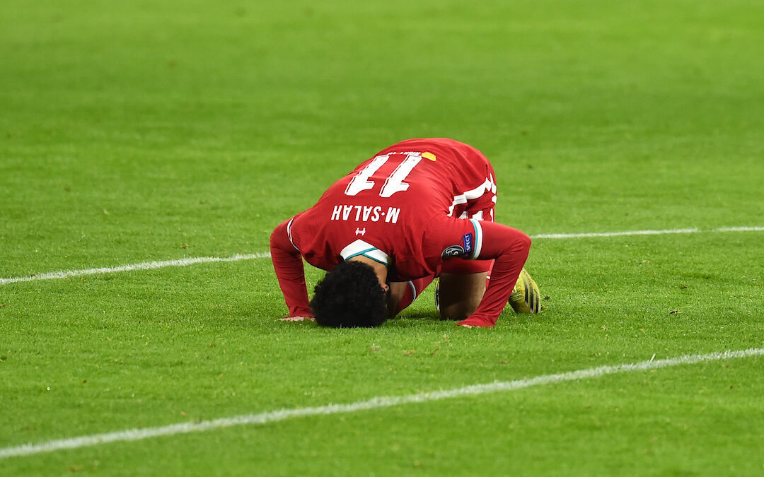 Liverpool's Mohamed Salah kneels to pray as he celebrates after scoring the first goal during the UEFA Champions League Round of 16 2nd Leg game between Liverpool FC and RB Leipzig at the Puskás Aréna