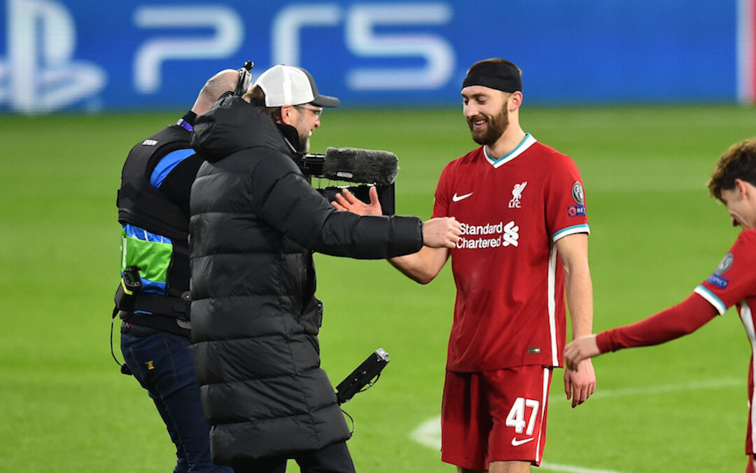 Liverpool's manager Jürgen Klopp embraces Nathaniel Phillips after the UEFA Champions League Round of 16 2nd Leg game between Liverpool FC and RB Leipzig at the Puskás Aréna