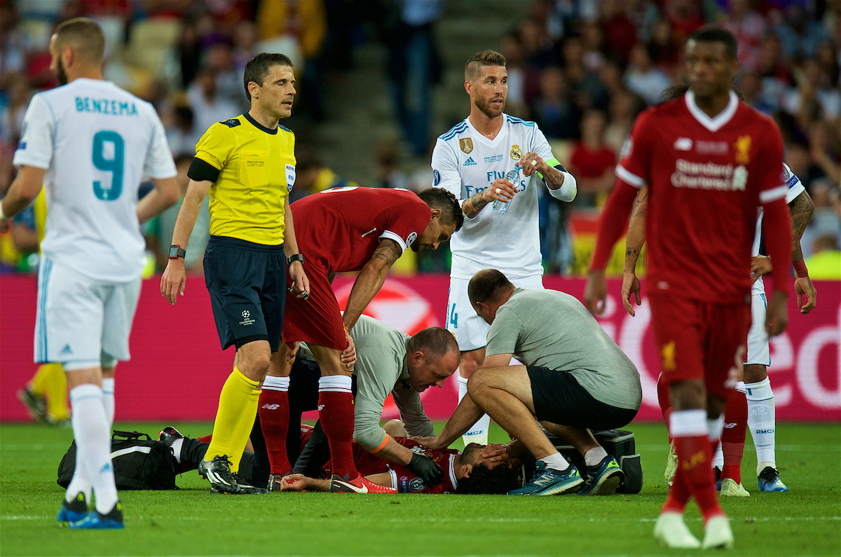 Liverpool's Mohamed Salah is treated for an injury after being fouled by Real Madrid's Sergio Ramos during the UEFA Champions League Final match between Real Madrid CF and Liverpool FC at the NSC Olimpiyskiy