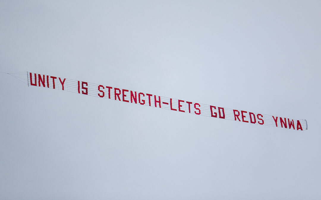 A plane banner flies over Anfield with the message "Unityt is strength - Lets (sic) go Reds YNWA" during the FA Premier League match between Liverpool FC and Fulham FC at Anfield