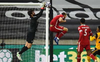 Liverpool's goalkeeper Alisson Becker fumbles the ball during the FA Premier League match between Wolves and Liverpool FC at Molineux Stadium