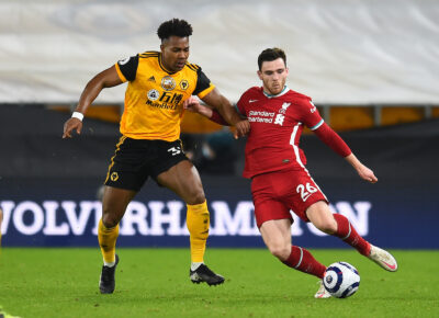 Andy Robertson and Adama Traore during the Premier League match between Wolves and Liverpool FC at Molineux Stadium
