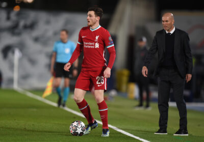 MADRID, SPAIN - Tuesday, April 6, 2021: Liverpool's Andy Robertson (L) and Real Madrid's head coach Zinédine Zidane during the UEFA Champions League Quarter-Final 1st Leg game between Real Madrid CF and Liverpool FC at the Estadio Alfredo Di Stefano.