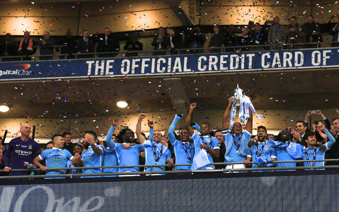 Manchester City lift the trophy after beating Liverpool on penalties during the Football League Cup Final match at Wembley Stadium.