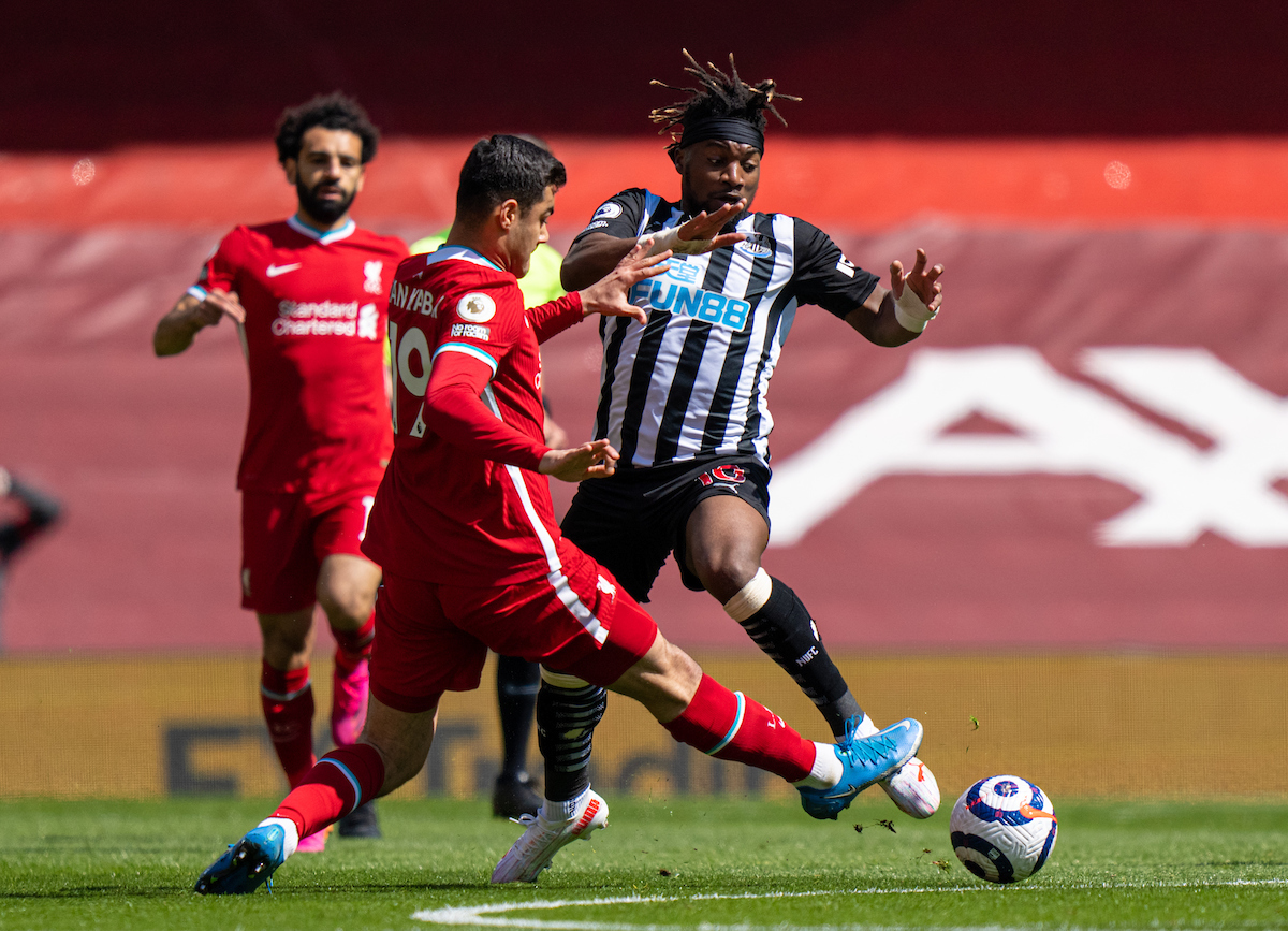 Liverpool's Ozan Kabak tackles Newcastle United's Allan Saint-Maximin (R) during the FA Premier League match between Liverpool FC and Newcastle United FC at Anfield.