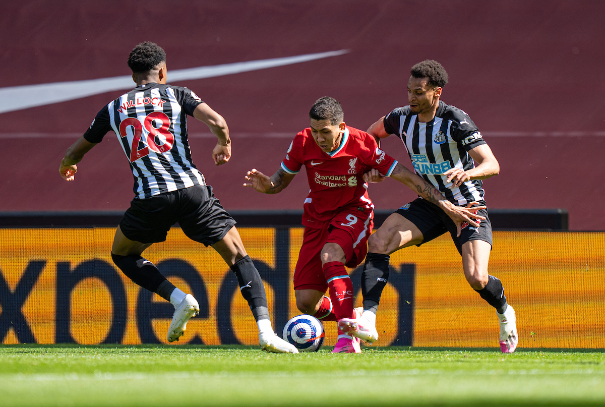 Liverpool's Roberto Firmino (C) is challenged by Newcastle United's Joe Willock (L) and Jacob Murphy (R) during the FA Premier League match between Liverpool FC and Newcastle United FC at Anfield.