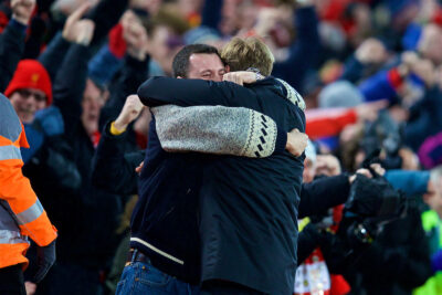 Liverpool manager Jurgen Klopp celebrates with a supporter at Anfield.