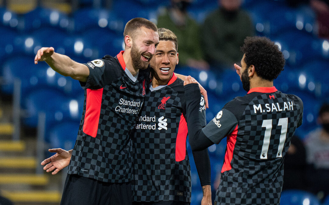 Liverpool's Nat Phillips (L) celebrates after scoring the second goal with team-mates Roberto Firmino (C) and Mohamed Salah (R) during the FA Premier League match between Burnley FC and Liverpool FC at Turf Moor.