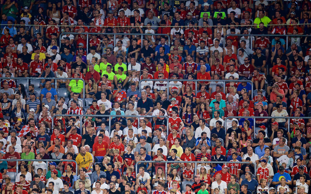 Liverpool supporters sitting in rail seating