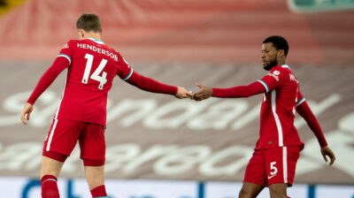 Liverpool's captain Jordan Henderson hands the captain's armband to Gini Wijnaldum