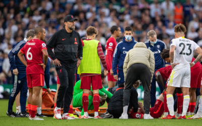 Liverpool's players look on as Harvey Elliott receives treatment for an injury before being carried off during the FA Premier League match between Leeds United FC and Liverpool FC at Elland Road
